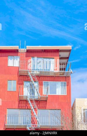 Immeubles d'appartements de plusieurs étages avec extérieur orange rouge et escaliers d'urgence à San Francisco, CA. Vue à angle bas d'un appartement avec photo de winpo Banque D'Images