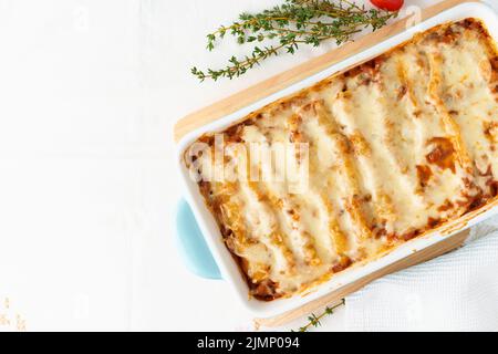 Pâtes de cannelloni avec remplissage de bœuf haché, tomates, cuites au bechamel Banque D'Images