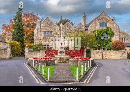 Le mémorial de guerre dans la ville de Melksham, dans le Wiltshire, le jour du souvenir. Un filet de coquelicots tricotés est drapé sur un mur de jardin formant un fond et le Banque D'Images