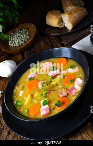 Soupe rustique aux petits pois avec bacon et saucisses Banque D'Images