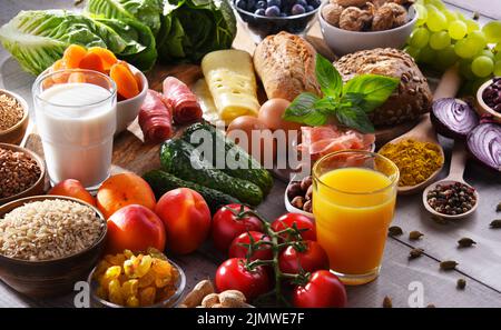 La composition avec un assortiment de produits alimentaires biologiques sur table de cuisine en bois. Banque D'Images