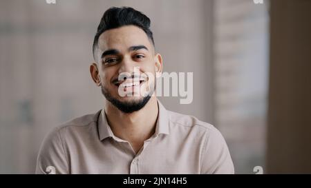 Portrait de confiant calme jeune homme arabe ethnique homme beau brunet Guy tourner la tête à la caméra heureux homme barbu visage positif sourire Banque D'Images