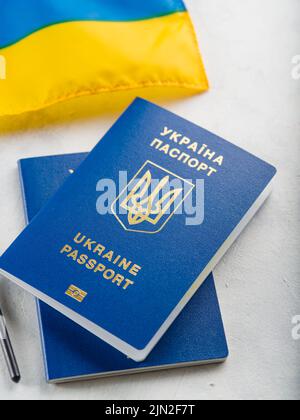 Gros plan. Deux passeports biométriques ukrainiens sur fond blanc : indépendance, patriotisme, liberté. Voyages, affaires, tourisme, guerre en Ukraine. Banque D'Images