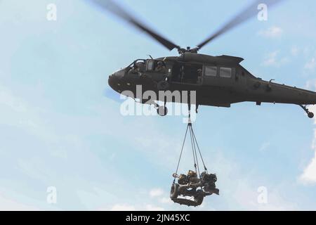 Une Armée américaine UH-60M Black Hawk affectée au 2nd Bataillon, 158th Aviation Regiment, 16th combat Aviation Brigade, porte un Howitzer M119A3 lors de l'instruction de chargement de harnais menée par des soldats américains affectés au 3rd Bataillon, 7th Field Artillery Regiment, 25th Infantry Division Artillery, 25th Infantry Division, Et des soldats du bataillon d'artillerie de campagne de 15th unités, Tentara Nasional Indonesia, pendant le Super Garuda Shield 2022 le 4 août 2022 à la zone d'entraînement de Baturaja, Indonésie. Le Super Garuda Shield 2022, qui fait partie de l'opération Pathways et d'un exercice militaire bilatéral annuel de longue date Banque D'Images