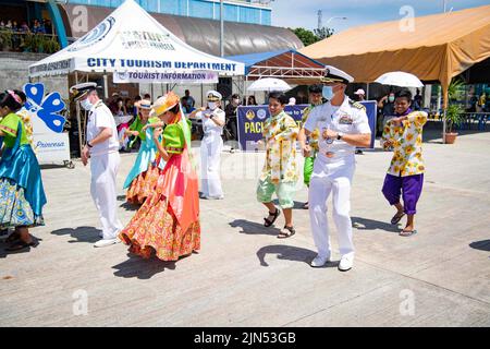 Puerto Princessa, Philippines. 2nd août 2022. Capitaine Hank Kim, à droite, Pacific Partnership 2022 (PP22) commandant de mission, Et le capitaine Charles Maynard de la Marine royale, qui a servi comme commandant de mission adjoint de PP22, dansait avec des danseurs culturels à l'arrivée du navire de l'hôpital militaire Sealift Command USNS Mercy (T-AH 19) à Puerto Princesa pendant le lancement de l'arrêt de la mission de PP22 aux Philippines. En 17th ans, le Partenariat Pacifique est la plus importante mission multinationale annuelle d'aide humanitaire et de préparation aux secours en cas de catastrophe menée dans l'Indo-Pacifique. (Image de crédit : Banque D'Images