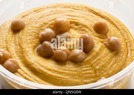 Bol en verre avec houmous de citrouille décoré de pois chiches gros plan Banque D'Images