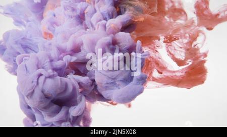 L'encre colorée se répand dans l'eau sur fond blanc Banque D'Images