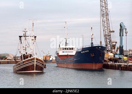 Ramsey, Île de Man - 16 juin 2022 : le port de Ramsey, un bateau de pêche et un cargo dans le port. Banque D'Images