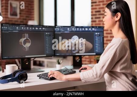 Femme technicien travaillant sur le développement de produits avec des engrenages et des machines de moteur. Technicien utilisant un logiciel industriel pour fabriquer des pièces de construction et la production d'ingénierie. Banque D'Images