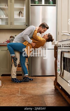 Son temps de Tango dans la cuisine. Photo d'un jeune couple affectueux dansant ensemble dans sa cuisine à venir. Banque D'Images