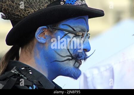 SIDMOUTH, DEVON, Royaume-Uni - 8 AOÛT 2017 les artistes du Sidmouth Folk Festival de Boggart's Breakfast aux visages bleus peints et aux vêtements noirs Banque D'Images