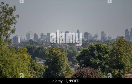 Wimbledon, Londres, Royaume-Uni. 10 août 2022. Les gratte-ciels du centre de Londres scintillent dans la chaleur qui se couche au-dessus des maisons de Wimbledon Hill alors que les températures continuent à grimper dans le sud-est de l'Angleterre. Crédit : Malcolm Park/Alay Live News. Banque D'Images