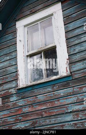 Gros plan sur une fenêtre en verre sur une ancienne maison abandonnée. Banque D'Images