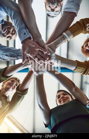 Les gens d'affaires qui gagnent, célèbrent et réussissent empilent les mains dans le bureau pour former des équipes. Groupe d'employés en accord sur l'unité, l'aide et Banque D'Images