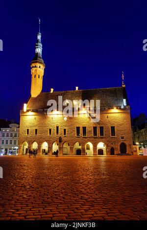 La place de l'hôtel de ville de Tallinn est illuminée la nuit après la pluie. Banque D'Images