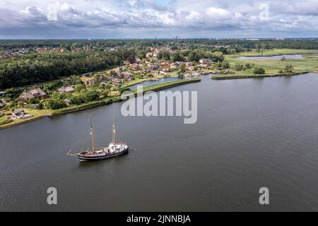 Photo de drone, tir de drone, historique Old Harbour Gothmund, maisons résidentielles avec toit de chaume maisons, vue sur la rivière Trave avec vieille voile Banque D'Images