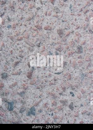 la texture brute de béton avec des mouchetures de granit rouge Banque D'Images