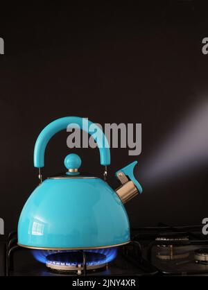 Électrique de l'eau bouillante sur une flamme de gaz de cuisson cuisine Banque D'Images