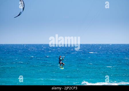 Homme kitesurf et saut dans la plage d'Agiokampos, Grèce Banque D'Images