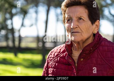 femme âgée de 90 ans triste et regardant le ciel de manière réfléchie. Banque D'Images