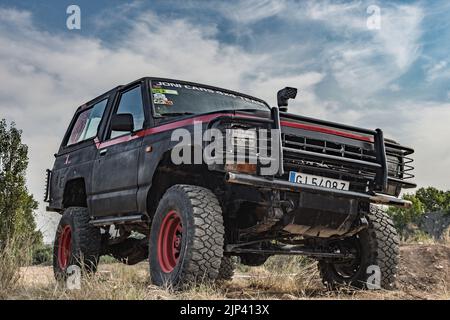 Une voiture Nissan Patrol Classic hors route qui court dans la boue Banque D'Images