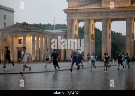 Berlin, Allemagne. 15th août 2022. Les passants traversent la Pariser Platz sous une forte pluie. Credit: Carsten Koall/dpa/Alay Live News Banque D'Images