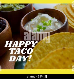 Composition du texte Happy taco day avec tacos sur la table. Image générée numériquement par le concept national de fête et de fête du taco. Banque D'Images