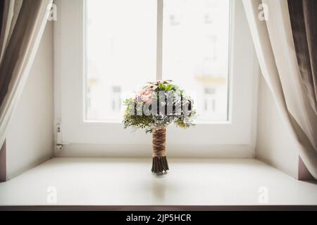 Bouquet de mariage coloré sur un seuil de fenêtre en bois. Banque D'Images