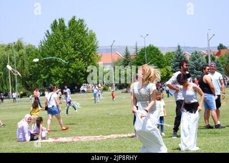 Les gens et les enfants s'amusent à la course de gunnysack en plein air en été Banque D'Images