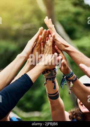 Allons faire du rafting. Un groupe de personnes méconnaissables ont soulevé les mains en l'air pour former un caucus à l'extérieur pendant la journée. Banque D'Images