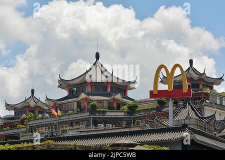 Les grandes arches jaunes de McDonald's au sommet d'un bâtiment traditionnel de style pagode à Shenzhen, en Chine Banque D'Images
