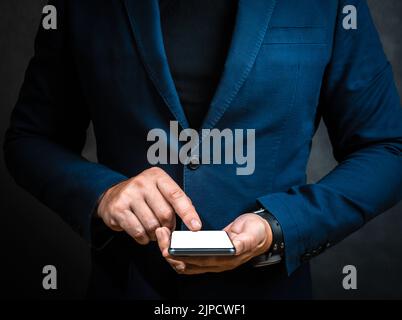 Homme main en costume et maquette écran vierge téléphone portable. Homme main tenant smartphone. Homme d'affaires tenant le téléphone. Gros plan d'un homme d'affaires utilisant cel Banque D'Images