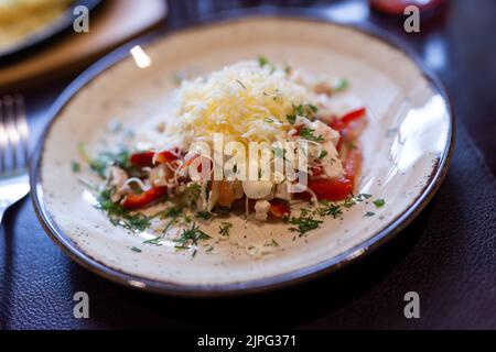 Salade fraîche avec poulet, légumes et fromage râpé sur l'assiette Banque D'Images