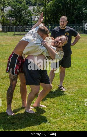 Les entraîneurs enseignent les règles et techniques de la Wrestling cornish avant le début du Grand Tournoi de la Wrestling cornish sur le village pittoresque g Banque D'Images