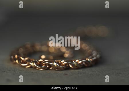 Gros plan d'un bracelet non fini sur une table d'orfèvre. Bijoux dans le processus de fabrication. Chaîne tissée à la main. Création de bijoux d'artisanat avec professionnel Banque D'Images