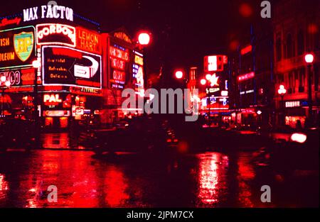 Enseignes publicitaires Neon à Night Piccadilly Circus, Londres, Angleterre, Royaume-Uni 1957 - Max Factor, British Petroluem BP, Gordons, Lemon Hart, Londres Pavilion cinéma montrant Kirk Douglas dans 'Paths of Glory' Banque D'Images