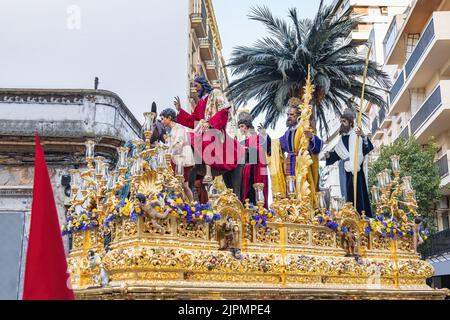 Le Christ est à cheval sur un âne dans le trône ou sur la plate-forme de la Fraternité de la Borriquita, en procession par les rues étroites de la ville Banque D'Images