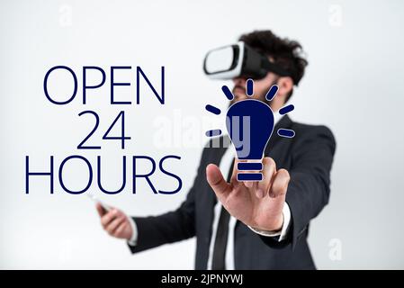 Texte d'écriture ouvert 24 heures, photo conceptuelle travailler toute la journée magasin d'affaires de tous les jours toujours en fonctionnement Homme portant des lunettes VR et pointant sur l'impor Banque D'Images