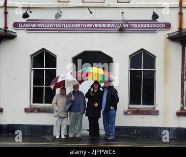 TOURISTES À LA STATION DÉLABRÉE AVEC LE NOM LE PLUS LONG DU MONDE À LLANFAIRPWLGWYNGYLLGOGERYCHWYRNDROBWLLLLANTYSILIOGOGOGOCH, DANS LE NORD DU PAYS DE GALLES PIC MIKE WALKER,2011 Banque D'Images