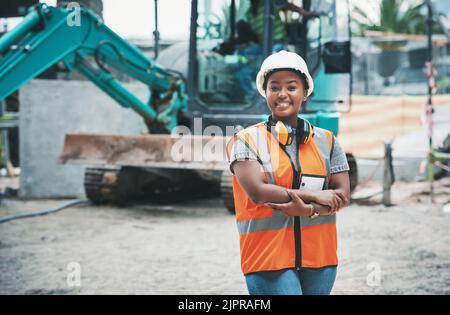 Femme heureuse travailleuse de construction avec un sourire prêt à travailler sur un chantier à l'extérieur. Portrait d'un jeune gestionnaire de développement de bâtiments fier sur le point du faire Banque D'Images