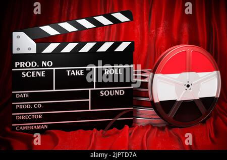 Cinéma yéménite, industrie cinématographique, cinéma au Yémen, concept. Clapperboard avec et bobines de film sur le tissu rouge, rendu 3D Banque D'Images