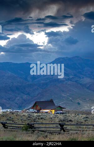 Nouvelle maison dans le paysage de la chaîne de montagnes Absaroka des montagnes Rocheuses au coucher du soleil, Wyoming Banque D'Images