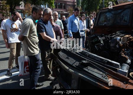Kiev, Ukraine. 21st août 2022. Les gens regardent les véhicules militaires russes détruits exposés dans la rue principale Khreshchatyk dans le cadre de la prochaine célébration du jour de l'indépendance de l'Ukraine dans le cadre de l'invasion de l'Ukraine par la Russie dans le centre de Kiev. (Credit image: © Oleksii Chumachenko/SOPA Images via ZUMA Press Wire) Banque D'Images