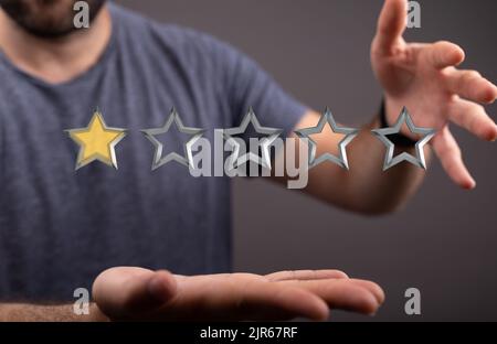 Un rendu en 3D d'un homme dans un t-shirt gris indiquant une note d'une étoile Banque D'Images