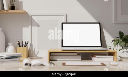 Gros plan, espace de travail blanc moderne avec maquette d'écran blanc pour ordinateur portable sur support en bois pour ordinateur portable, papeterie, livre, clavier et maquette de cadre vide sur whit Banque D'Images