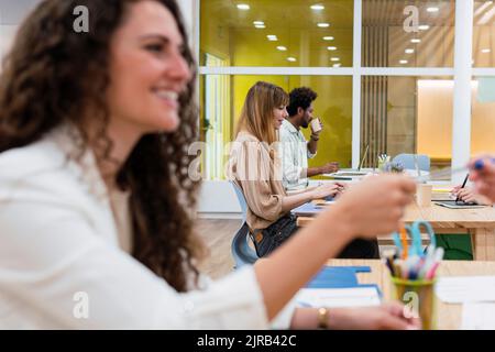 Femme d'affaires qui a remis le stylo à un collègue au bureau Banque D'Images