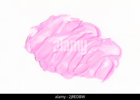 Écouvillons de texture crémeuse de couleur rose. Frottis de produit cosmétique pour les soins de la peau de couleur rose. Des coups de crème de maquillage, de lotion hydratante pour le corps ou de crème pour les mains. Banque D'Images