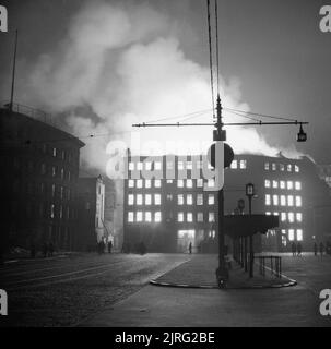 Le Blitz de Manchester bâtiments entourant une station de bus dans la région de Manchester à brûler après un raid aérien allemand dans la nuit du 23 décembre 1940. Banque D'Images