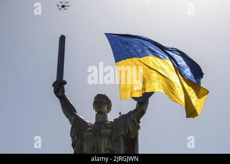 Kiev, Ukraine. 24th août 2022. Un drone battant un drapeau national ukrainien géant passe au-dessus du monument de la mère patrie à Kiev, en Ukraine, lors du jour de l'indépendance de l'Ukraine, au milieu de l'invasion russe de l'Ukraine mercredi, 24 août 2022. Photo de Vladyslav Musiienko /UPI crédit: UPI/Alay Live News Banque D'Images