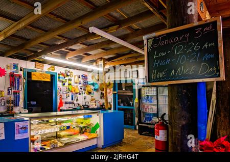 Les périodes de marée haute et basse sont inscrites sur un tableau de surveillance au Bait-N-Tackle de Jemison, 3 janvier 2017, à Coden, Alabama. La boutique d'appâts a ouvert ses portes en 1940s. Banque D'Images